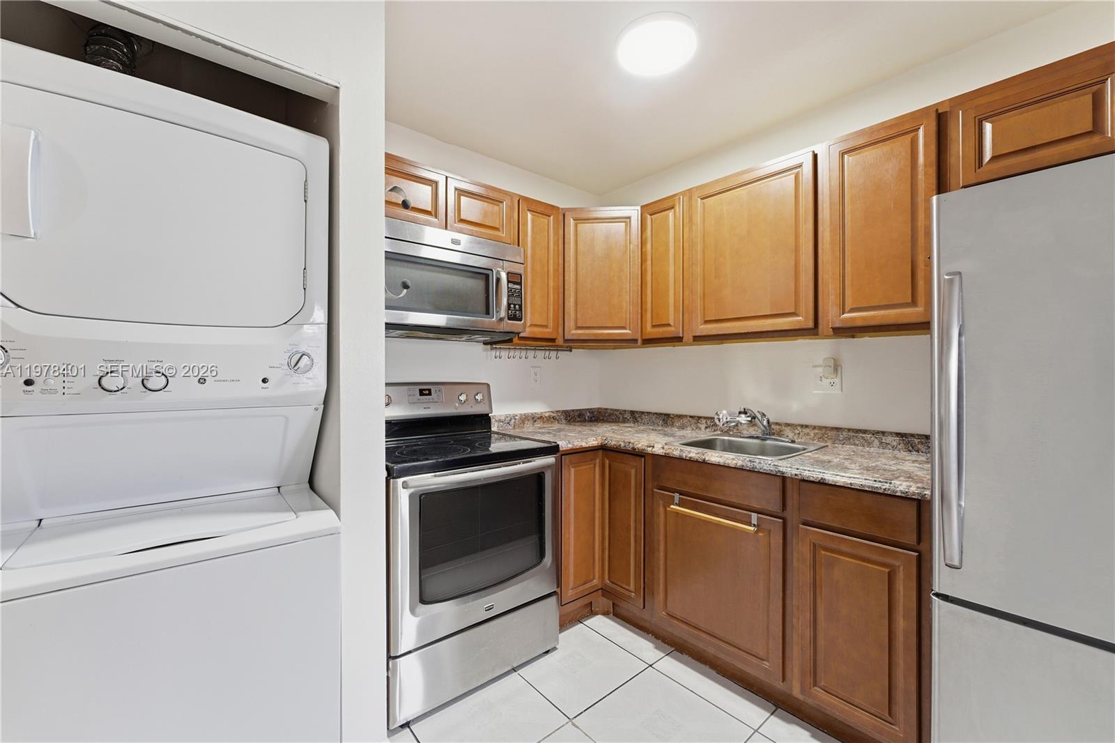 6921 Southwest 129th Avenue, Unit 5 Miami, FL 33183 - Photo 7 of 34 a kitchen with a stove microwave and sink