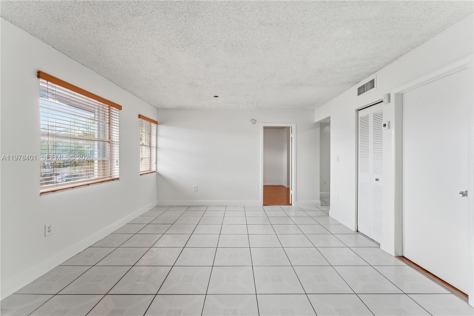 6921 Southwest 129th Avenue, Unit 5 Miami, FL 33183 - Photo 9 of 34 a view of an empty room with window and chandelier fan