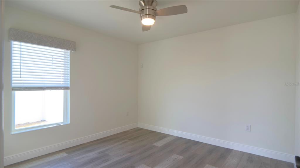 13574 Southwest 47th Circle Ocala, FL 34473 - Photo 15 of 25 an empty room with a window and wooden floor