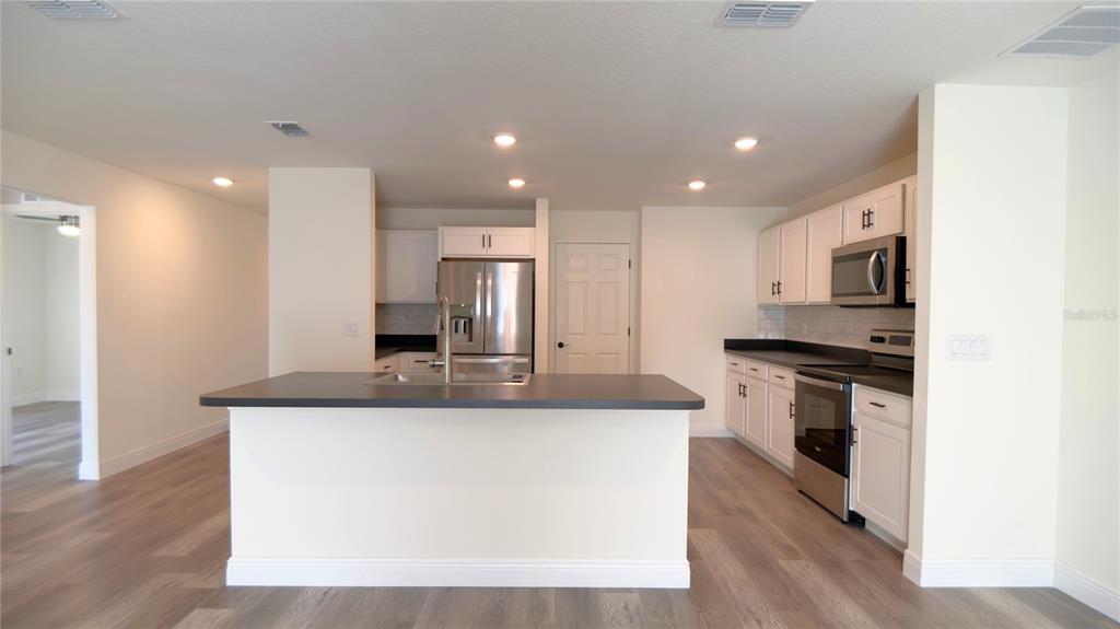 13574 Southwest 47th Circle Ocala, FL 34473 - Photo 16 of 25 a kitchen with stainless steel appliances granite countertop a sink and a microwave
