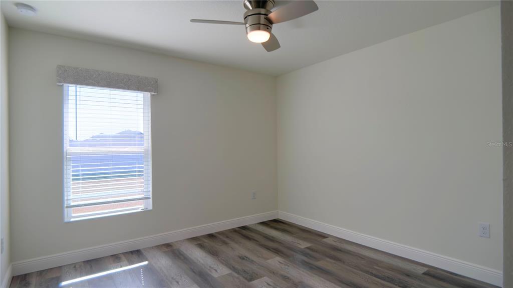 13574 Southwest 47th Circle Ocala, FL 34473 - Photo 17 of 25 a view of an empty room with wooden floor and a window