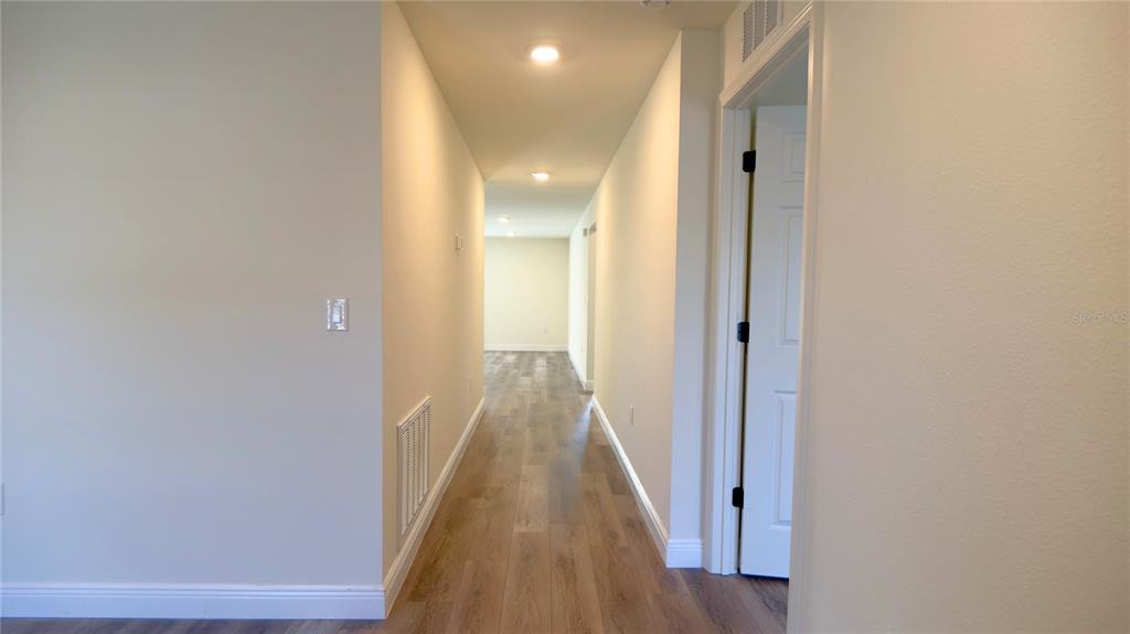 13574 Southwest 47th Circle Ocala, FL 34473 - Photo 21 of 25 a view of a hallway with wooden floor