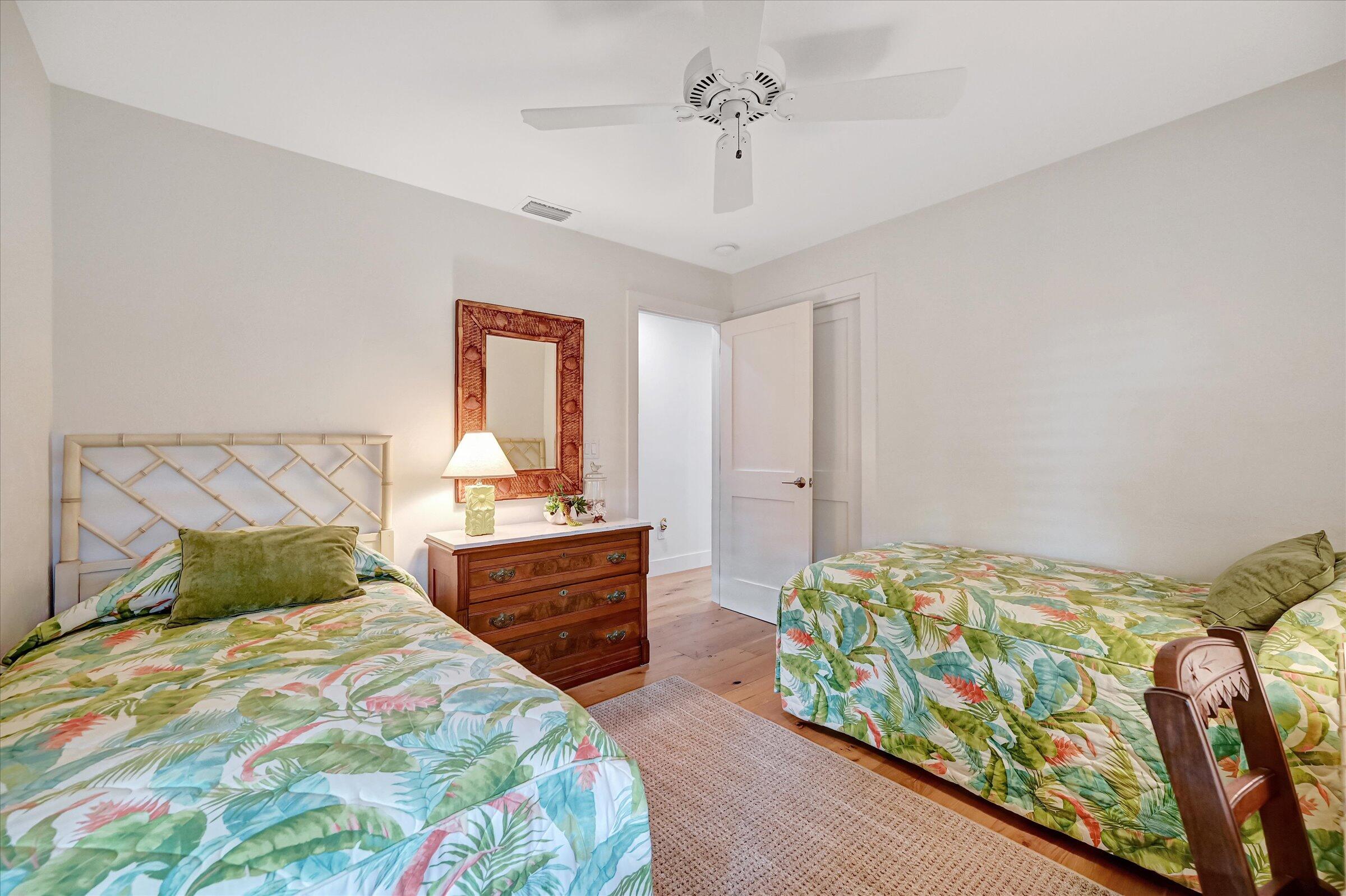 535 Augusta Boulevard, Unit 4 Naples, FL 34113 - Photo 40 of 44 a bedroom with a bed and a dresser in it