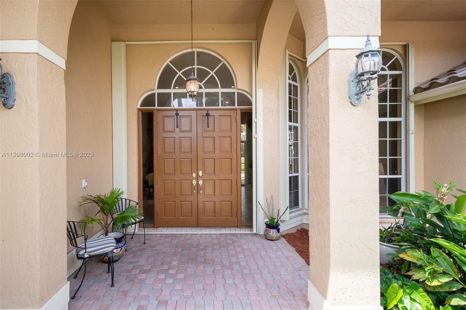 3155 Inverness Weston, FL 33332 - Photo 18 of 58 a front view of a house with a glass door and glass door