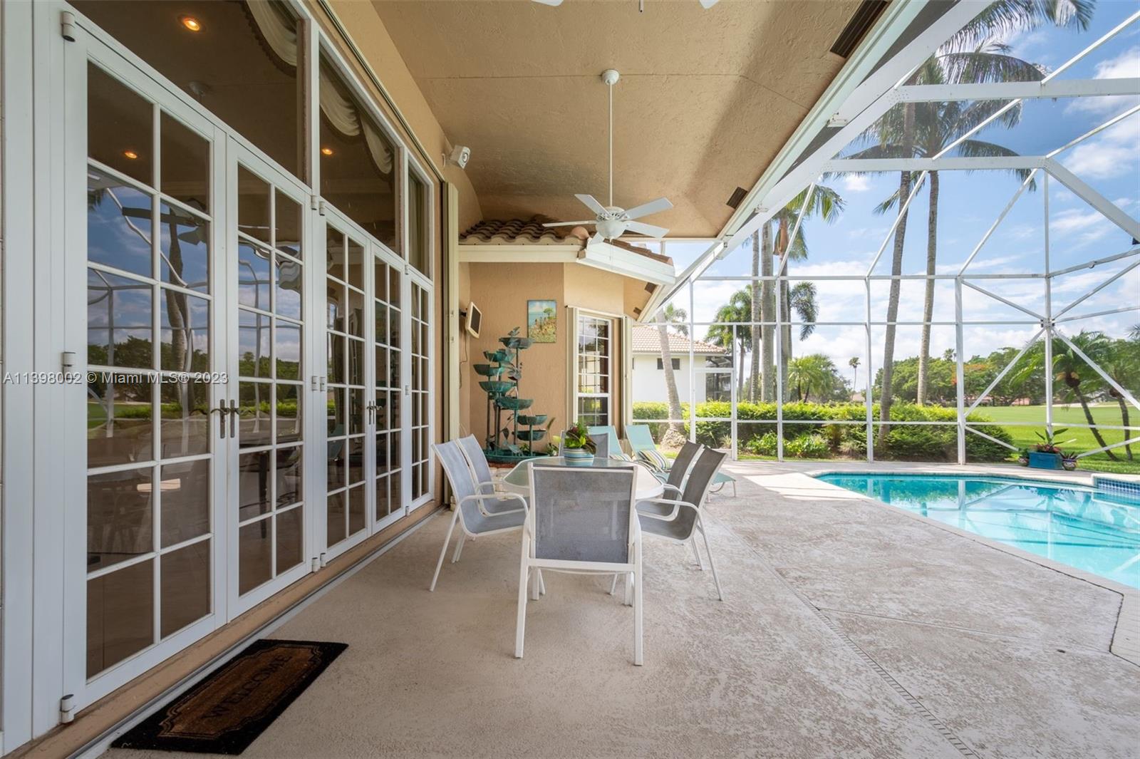3155 Inverness Weston, FL 33332 - Photo 25 of 58 a view of a porch with chairs and floor to ceiling window