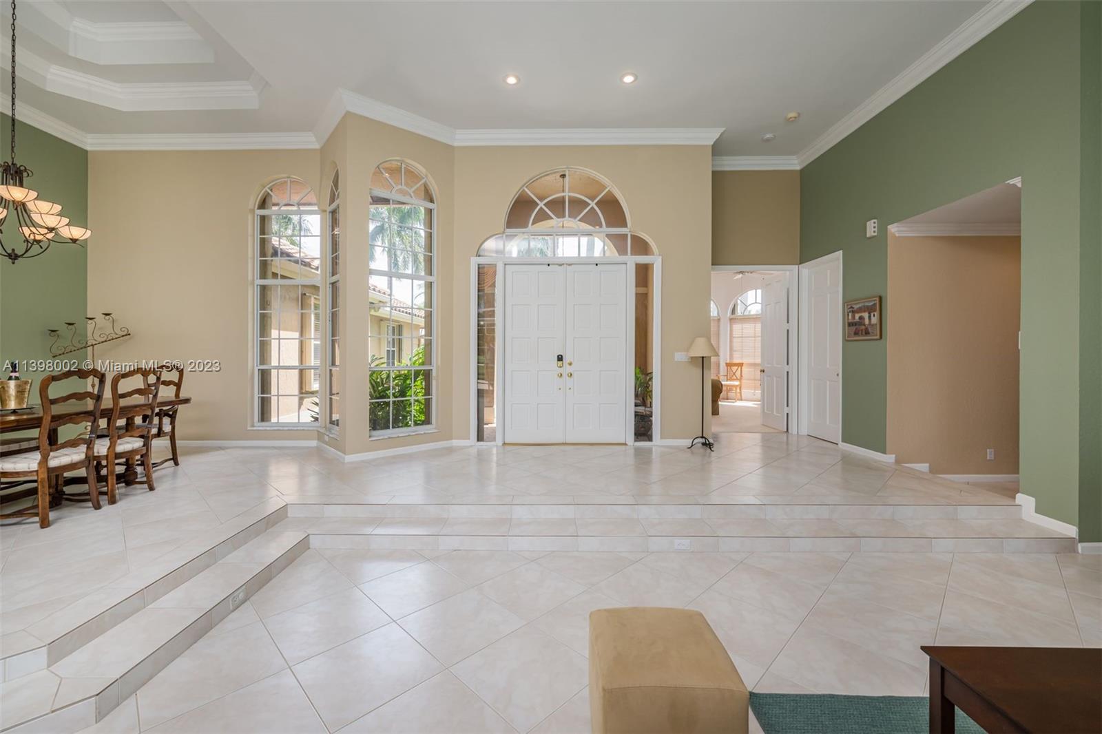 3155 Inverness Weston, FL 33332 - Photo 29 of 58 a large white kitchen with granite countertop a couch and a large window