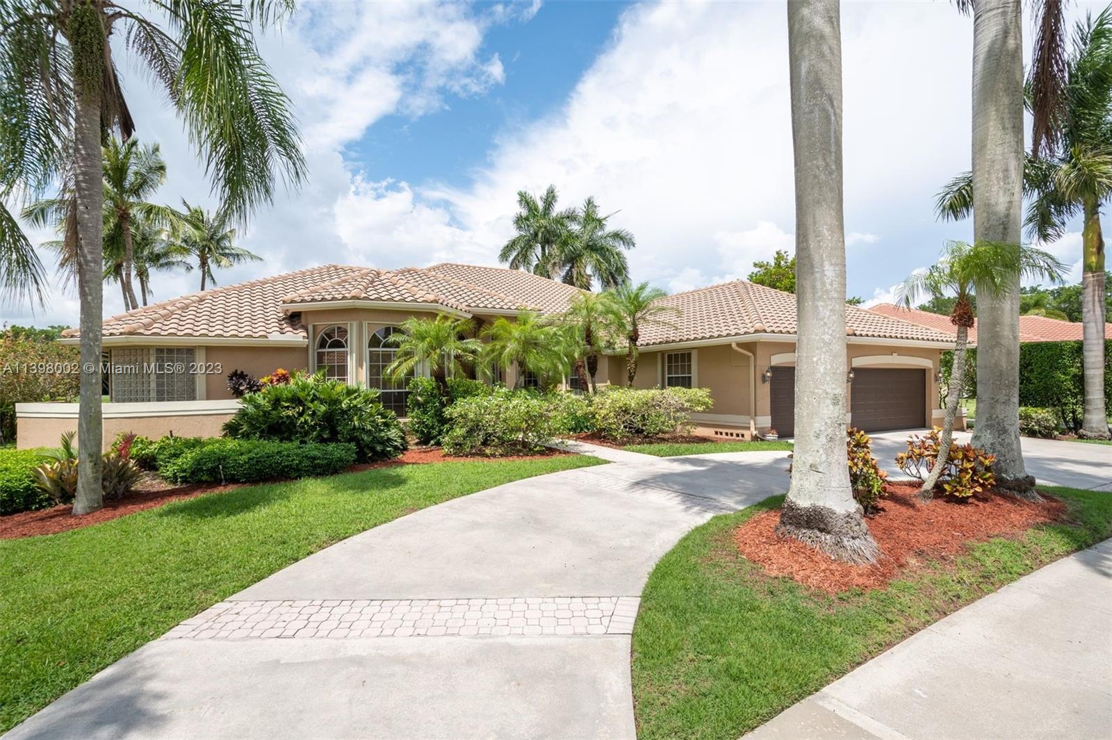 3155 Inverness Weston, FL 33332 - Photo 3 of 58 a front view of a house with garden and patio