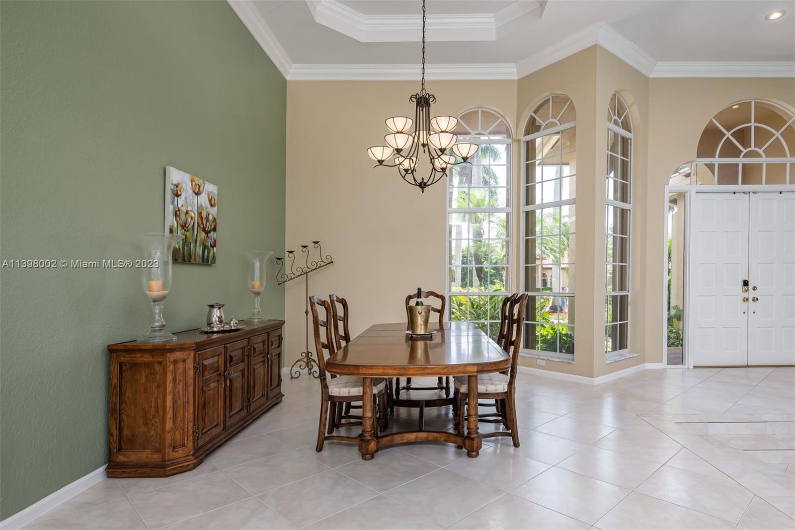 3155 Inverness Weston, FL 33332 - Photo 31 of 58 a view of a dining room with furniture a chandelier and a window