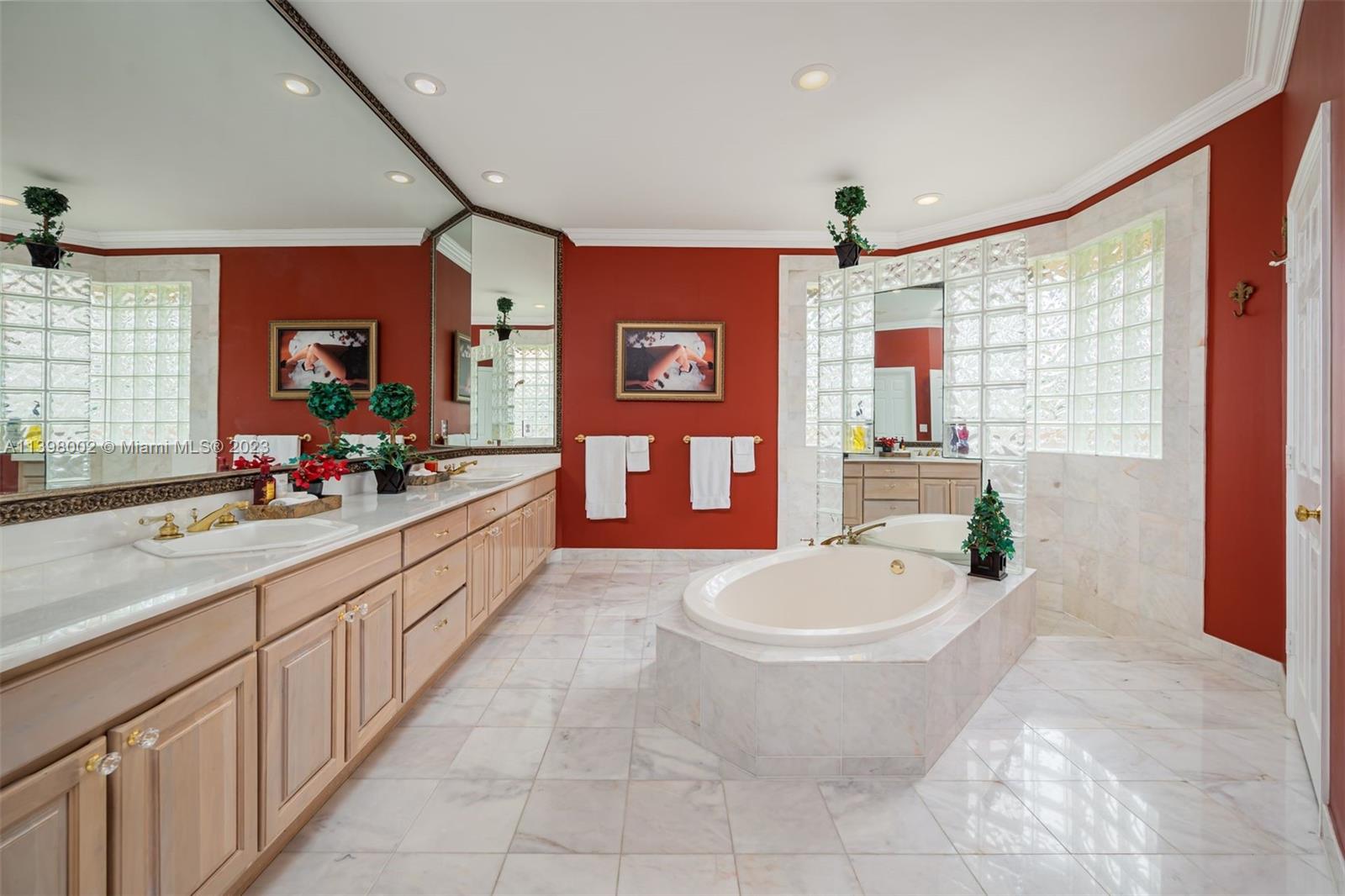 3155 Inverness Weston, FL 33332 - Photo 37 of 58 a large spacious bathroom with a double vanity sink a mirror and a bathtub