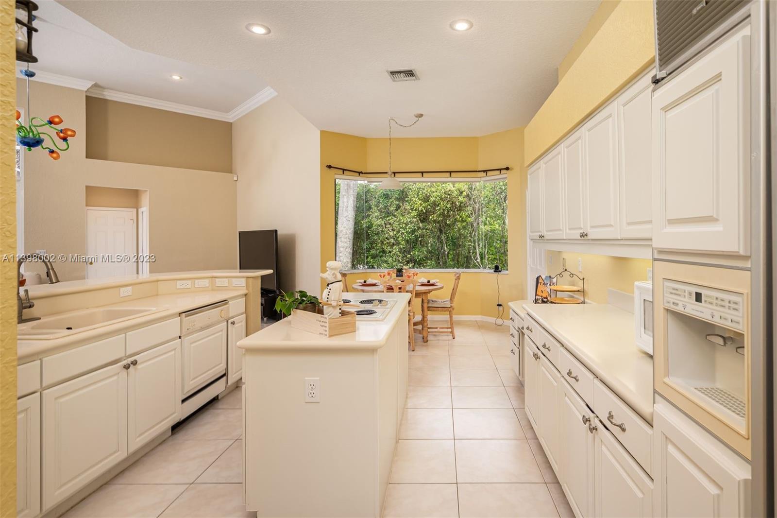 3155 Inverness Weston, FL 33332 - Photo 43 of 58 a large white kitchen with a large window