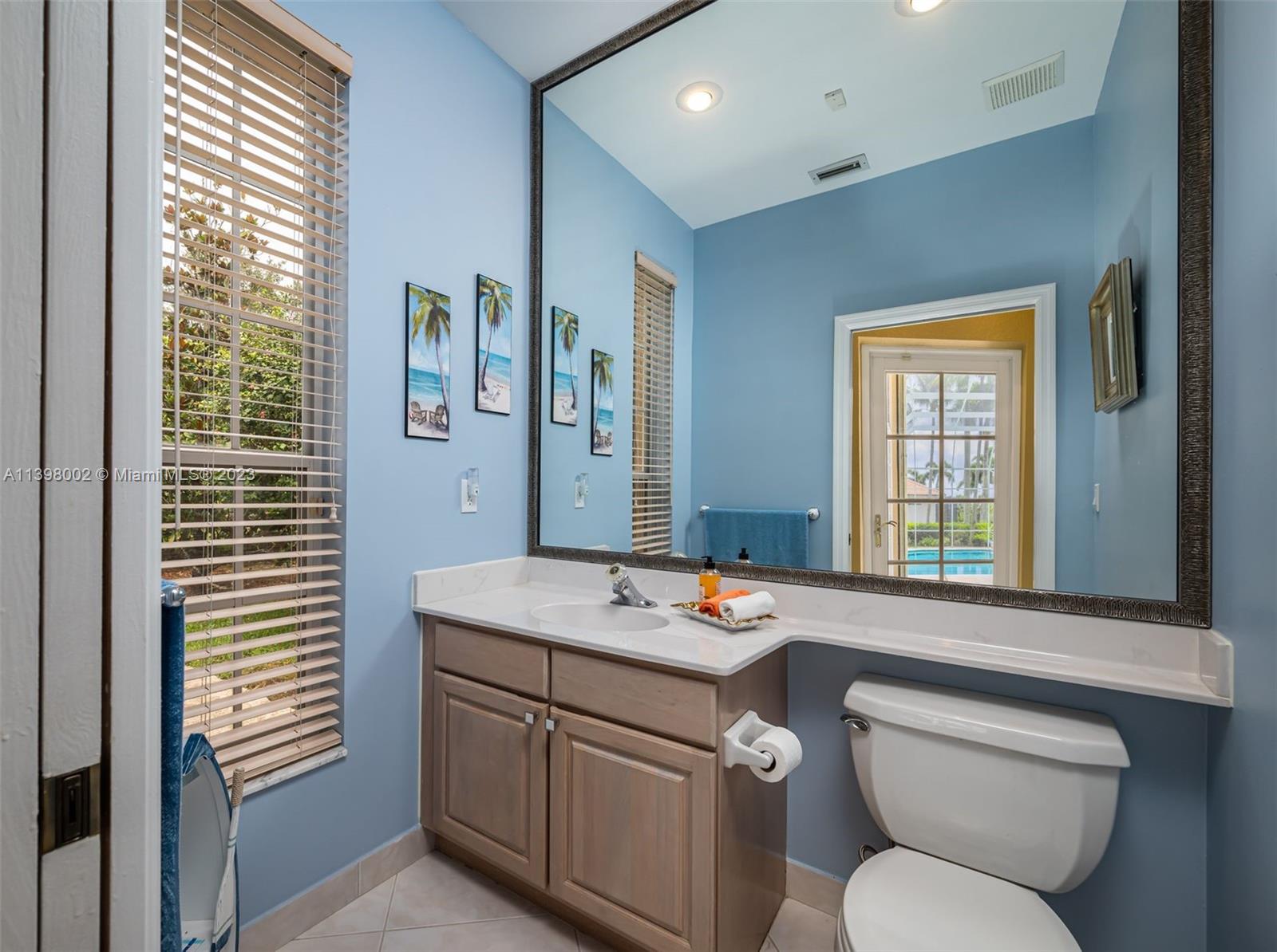 3155 Inverness Weston, FL 33332 - Photo 47 of 58 a bathroom with a toilet sink and mirror