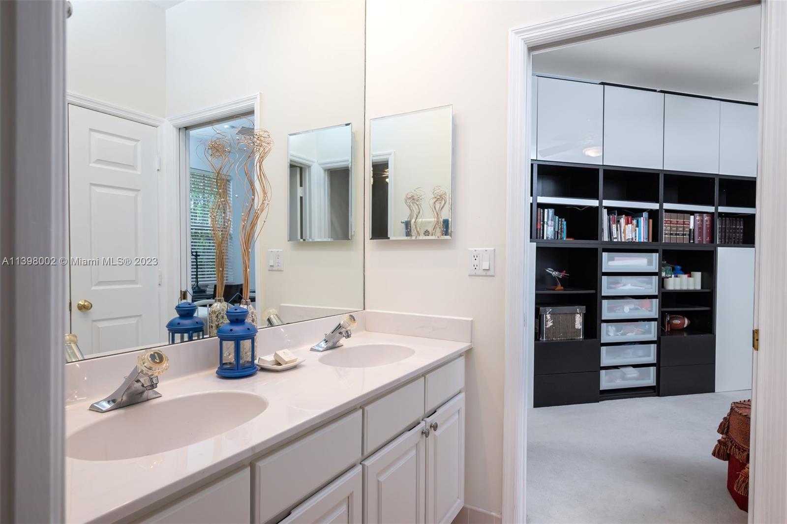 3155 Inverness Weston, FL 33332 - Photo 50 of 58 a bathroom with a sink double vanity and a mirror