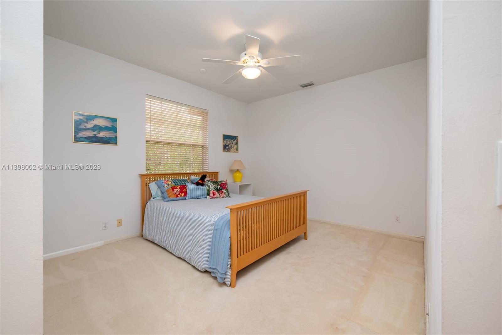 3155 Inverness Weston, FL 33332 - Photo 51 of 58 a bed room with a bed and a chandelier