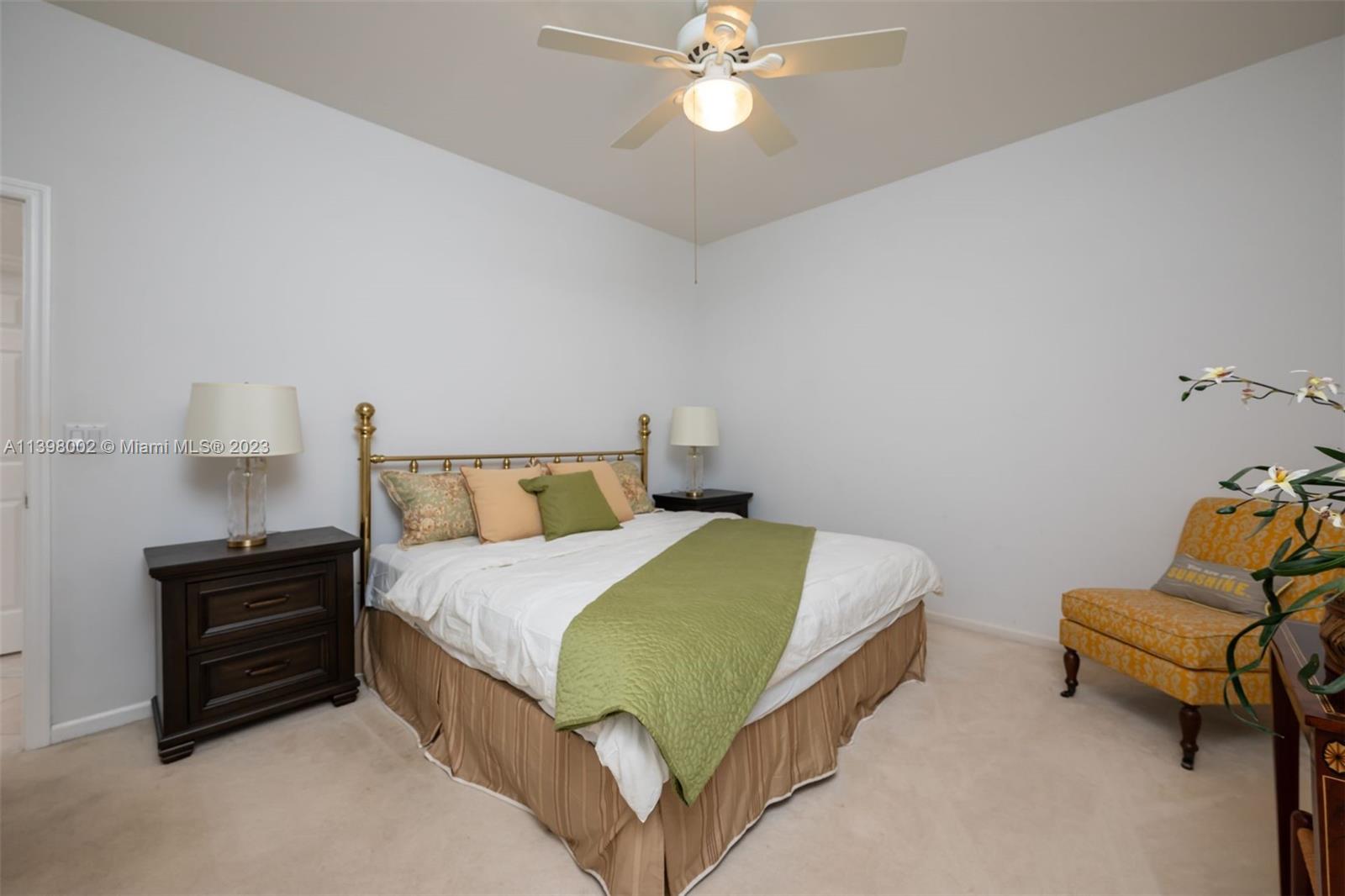 3155 Inverness Weston, FL 33332 - Photo 52 of 58 a bedroom with a bed and a chandelier