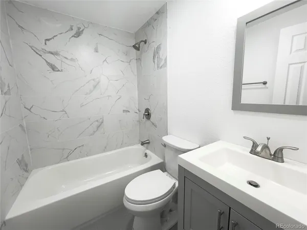 a bathroom with a sink toilet and bathtub