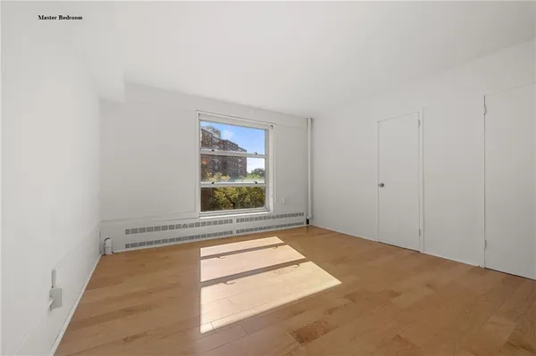 a bedroom with a bed and a television