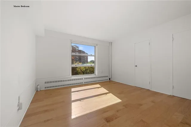 a bedroom with a bed and a television