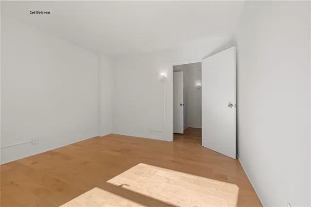 a white bath tub sitting next to a white sink and vanity