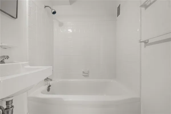 a kitchen with stainless steel appliances granite countertop a stove a sink and white cabinets