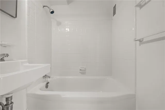 a kitchen with stainless steel appliances granite countertop a stove a sink and white cabinets