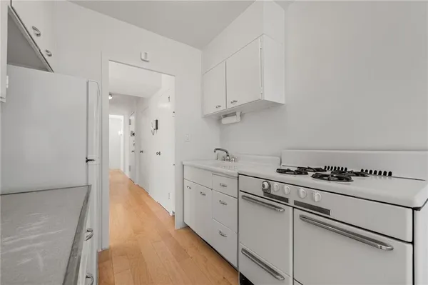 a kitchen with a white cabinets and white appliances