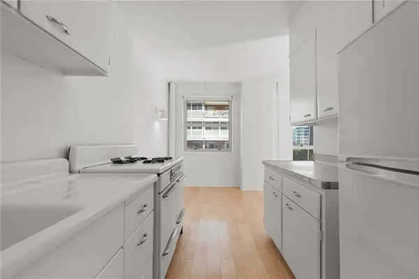 a kitchen with a sink stove and cabinets