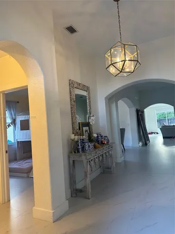 a view of a dining room with furniture and chandelier
