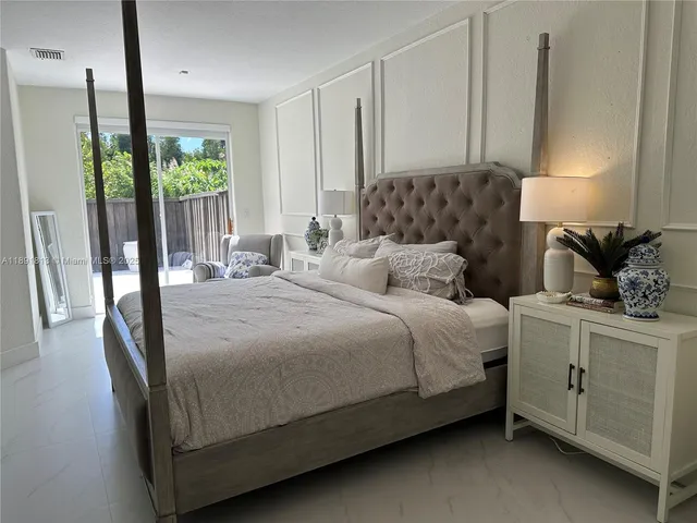 a bedroom with a large bed and a window