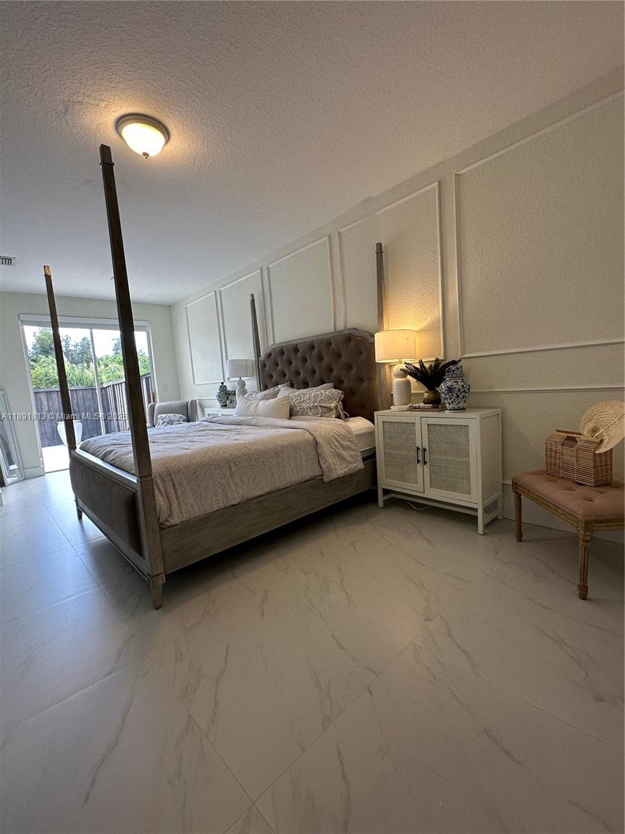 3744 Southwest 156th Court Miami, FL 33185 - Photo 7 of 10 a spacious bedroom with a bed and large window