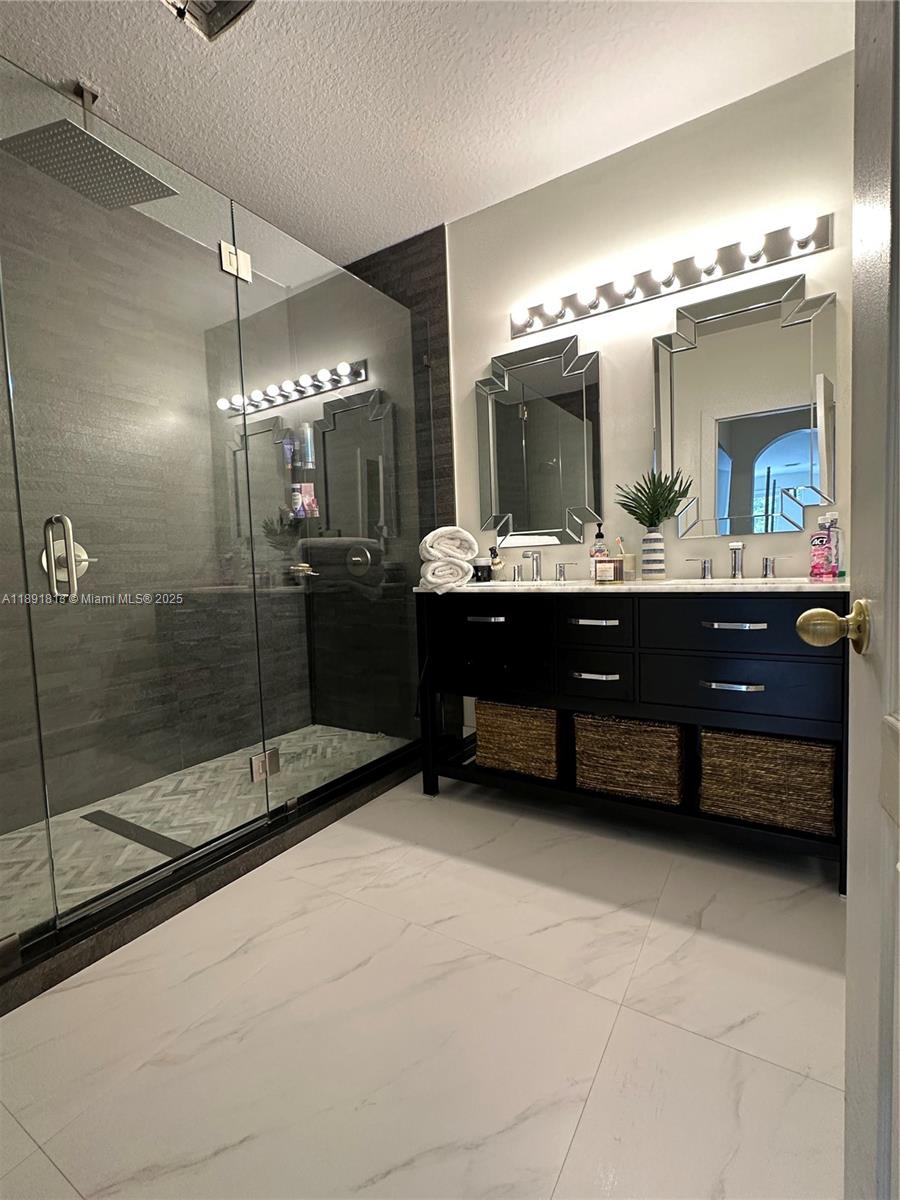 3744 Southwest 156th Court Miami, FL 33185 - Photo 8 of 10 a bathroom with a tub sink shower and mirror