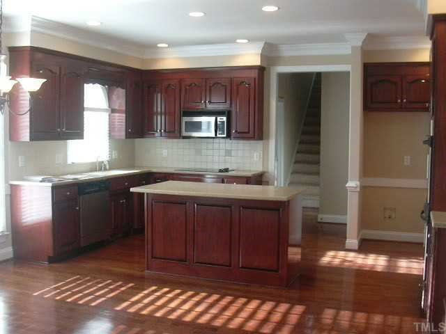 9420 Stone Mountain Road Raleigh, NC 27613 - Photo 4 of 12 Great kitchen with beautiful cabinets, solid surface countertops, stainless appliances & double ovens Kitchen