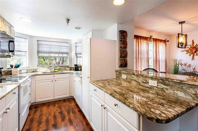 a kitchen with sink stove and refrigerator