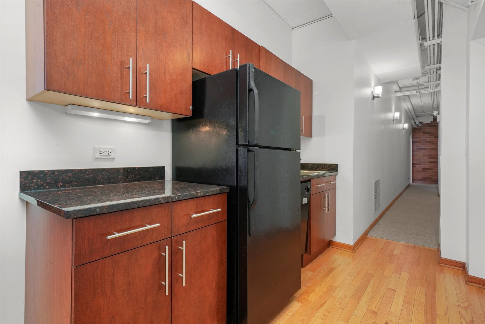 Undisclosed Address Chicago, IL 60654 - Photo 11 of 24 a kitchen with stainless steel appliances granite countertop a refrigerator and a stove