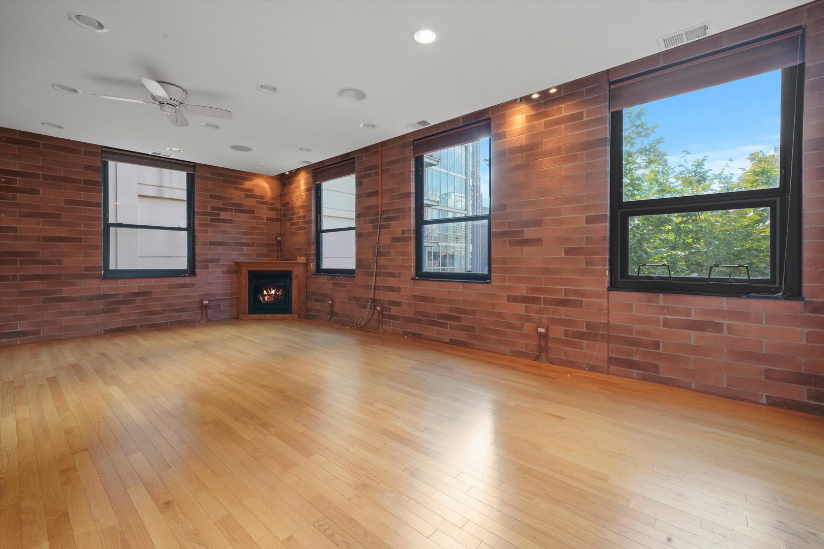 Undisclosed Address Chicago, IL 60654 - Photo 13 of 24 a view of an empty room with a fireplace and a window