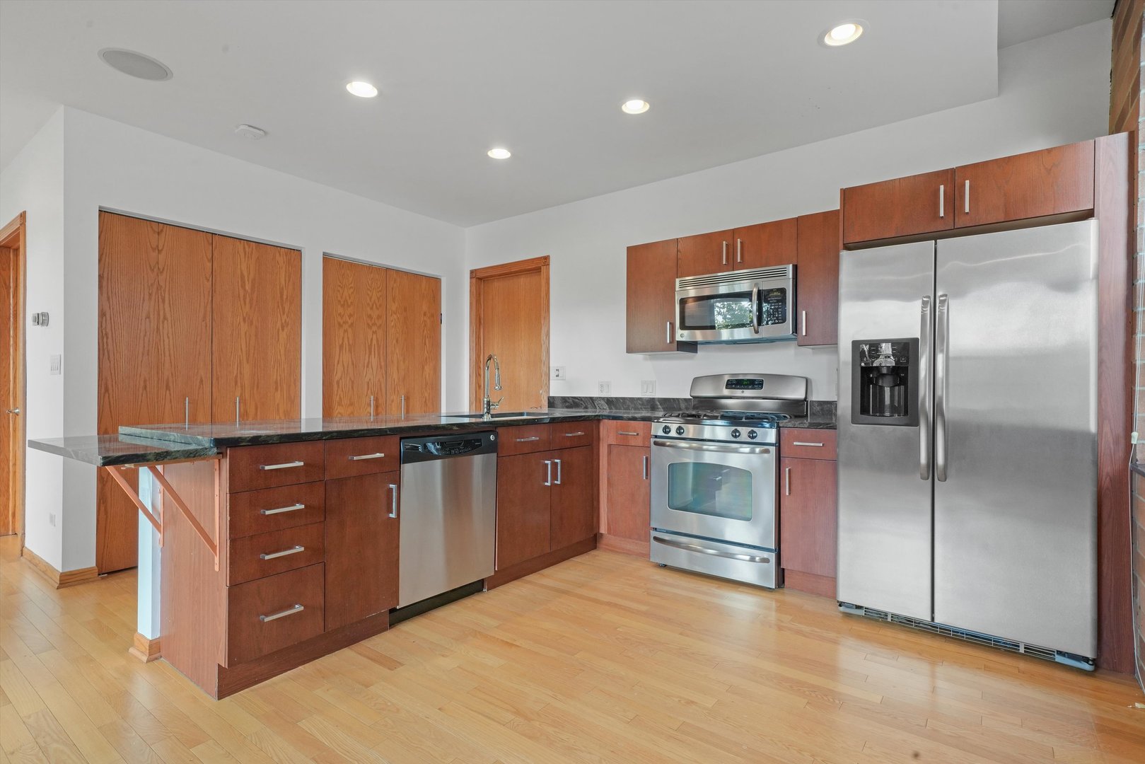 Undisclosed Address Chicago, IL 60654 - Photo 15 of 24 a kitchen with stainless steel appliances granite countertop a refrigerator and a stove