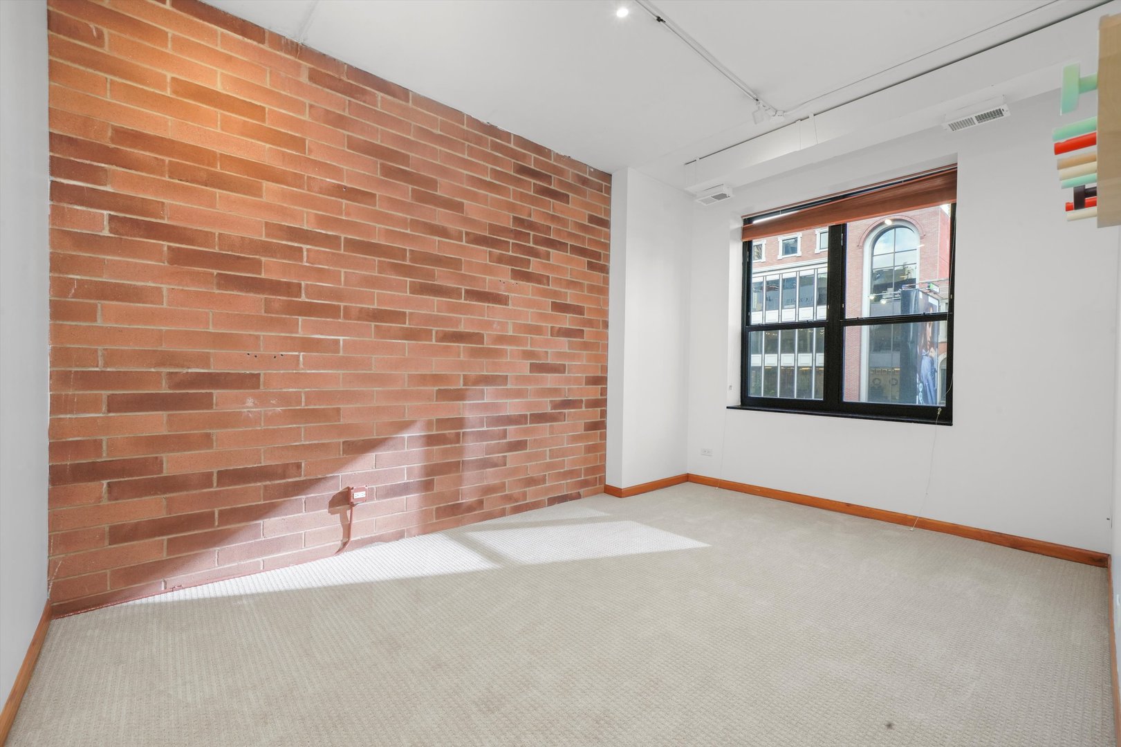 Undisclosed Address Chicago, IL 60654 - Photo 8 of 24 a view of an empty room with a window