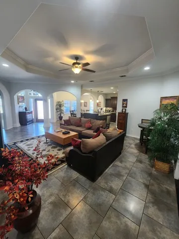 a living room with furniture and a chandelier