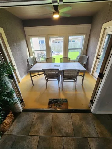 a view of a livingroom with furniture and a floor to ceiling window