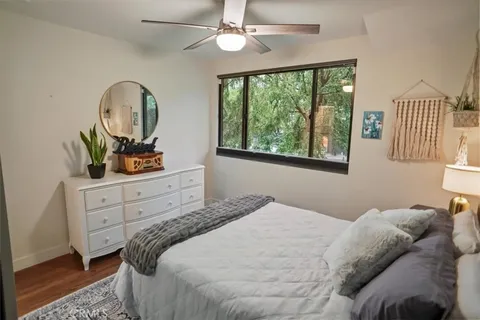 a bedroom with a bed and a dresser with the large mirror
