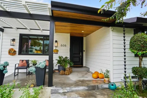a view of a porch with dining table and chairs potted plants