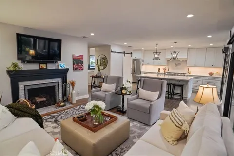 a living room with furniture fireplace and flat screen tv