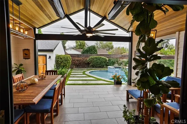 a view of house with a swimming pool and outdoor seating