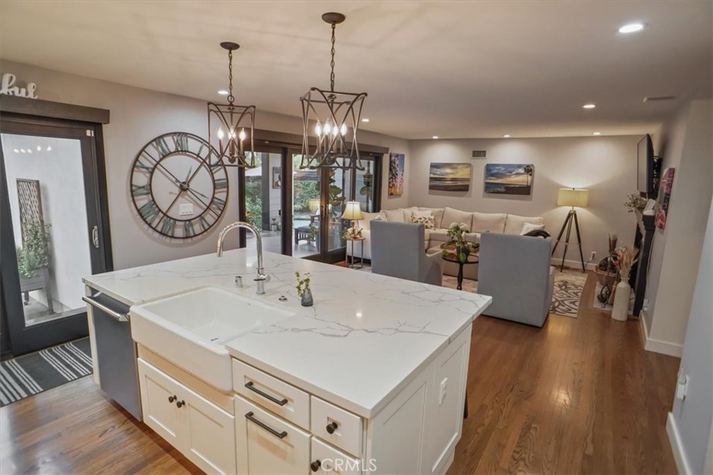 606 Uclan Drive Burbank, CA 91504 - Photo 6 of 18 a view of a kitchen with kitchen island a sink a stove and wooden floor