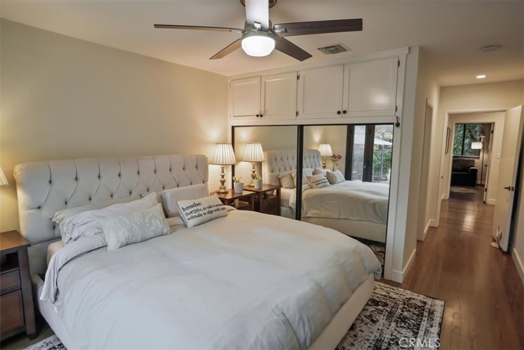 606 Uclan Drive Burbank, CA 91504 - Photo 9 of 18 a large bedroom with a bed and a chandelier