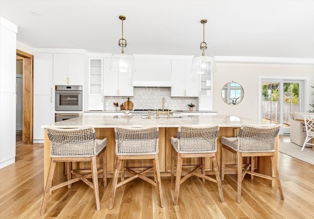 34 Otis Hill Road Hingham, MA 02043 - Photo 16 of 42 a dining room with kitchen island granite countertop a table and chairs in it