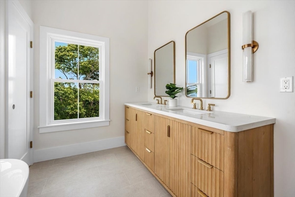 34 Otis Hill Road Hingham, MA 02043 - Photo 24 of 42 a bathroom with a double vanity sink window and a mirror