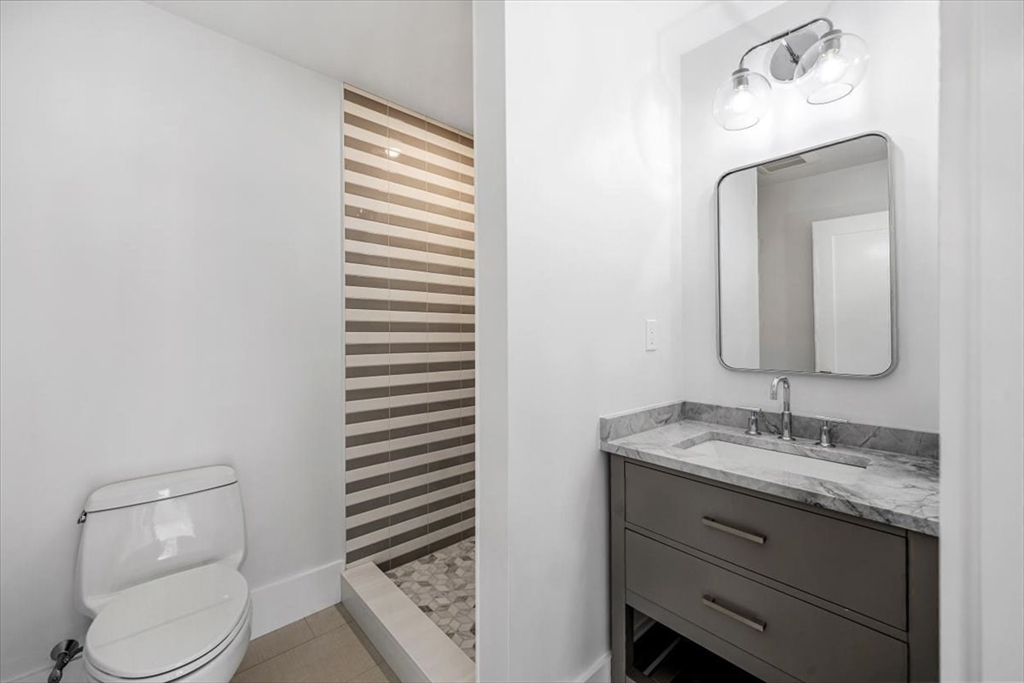 34 Otis Hill Road Hingham, MA 02043 - Photo 27 of 42 a bathroom with a granite countertop toilet sink and mirror