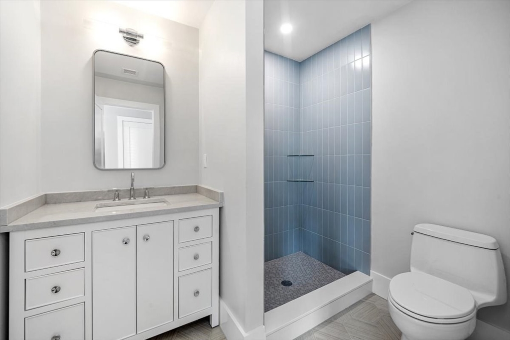 34 Otis Hill Road Hingham, MA 02043 - Photo 31 of 42 a bathroom with a granite countertop toilet a sink and mirror