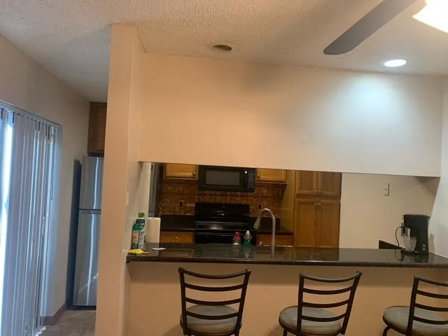 a kitchen with a refrigerator and cabinets