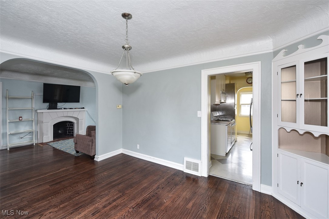 999 Pennfield Road Cleveland, OH 44121 - Photo 8 of 42 Unfurnished living room with hardwood / wood-style floors and a textured ceiling